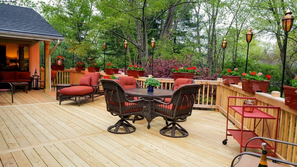 deck with outdoor furniture and plants