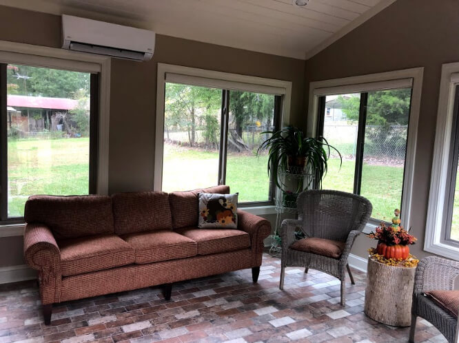 Cozy custom sunroom with backyard view