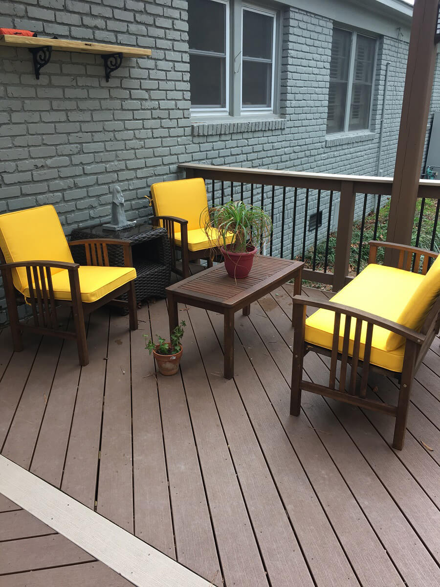 Seating area on deck with yellow cushions