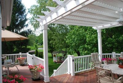 Large deck with with white vinyl pergola