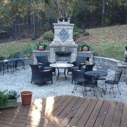 This deck in Irmo SC overlooks a serene hardscape patio with outdoor fireplace
