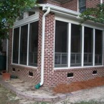 This vinyl four-track aluminum three season room with brick exterior blends seamlessly with home in Columbia. SC