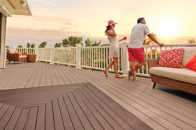 Man and women standing on their deck at sunset