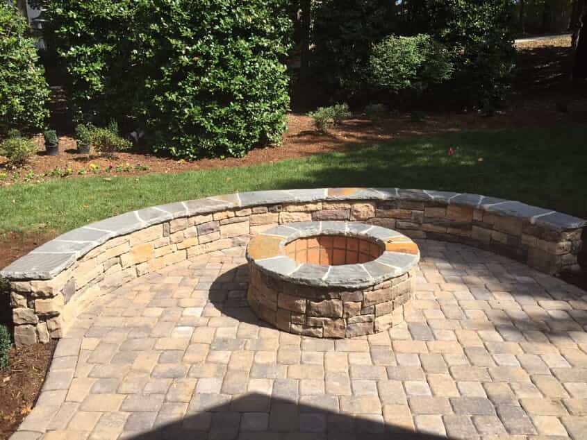stone patio with built in firepit and sitting wall