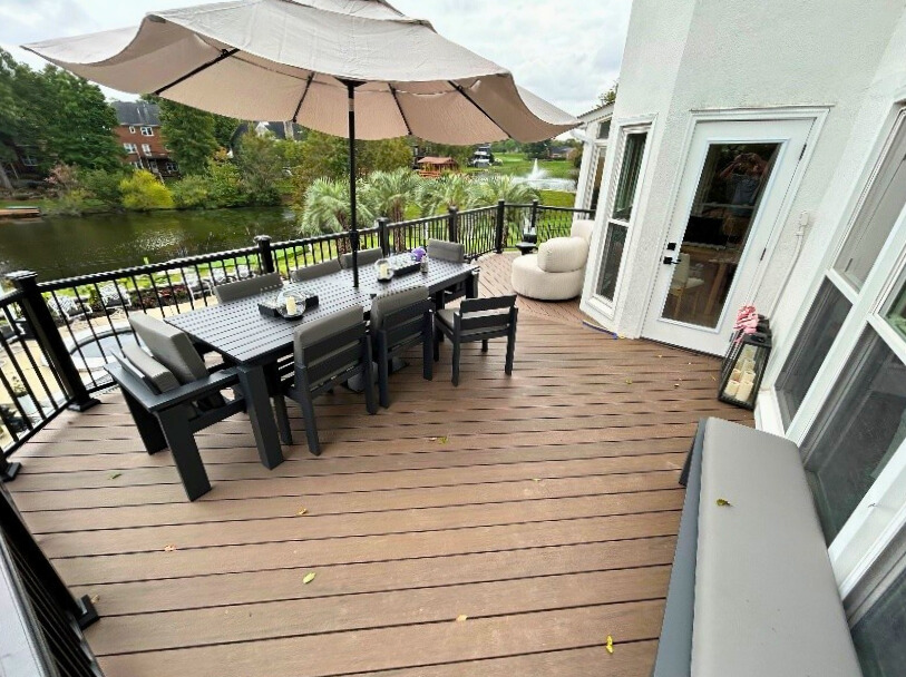 Luxury composite deck with dining set and lake view in Fort Mill, built by a local deck builder. 