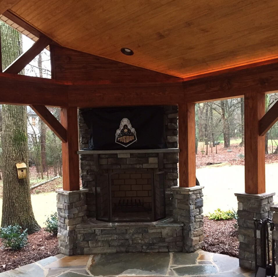 Covered outdoor space with a built in fireplace