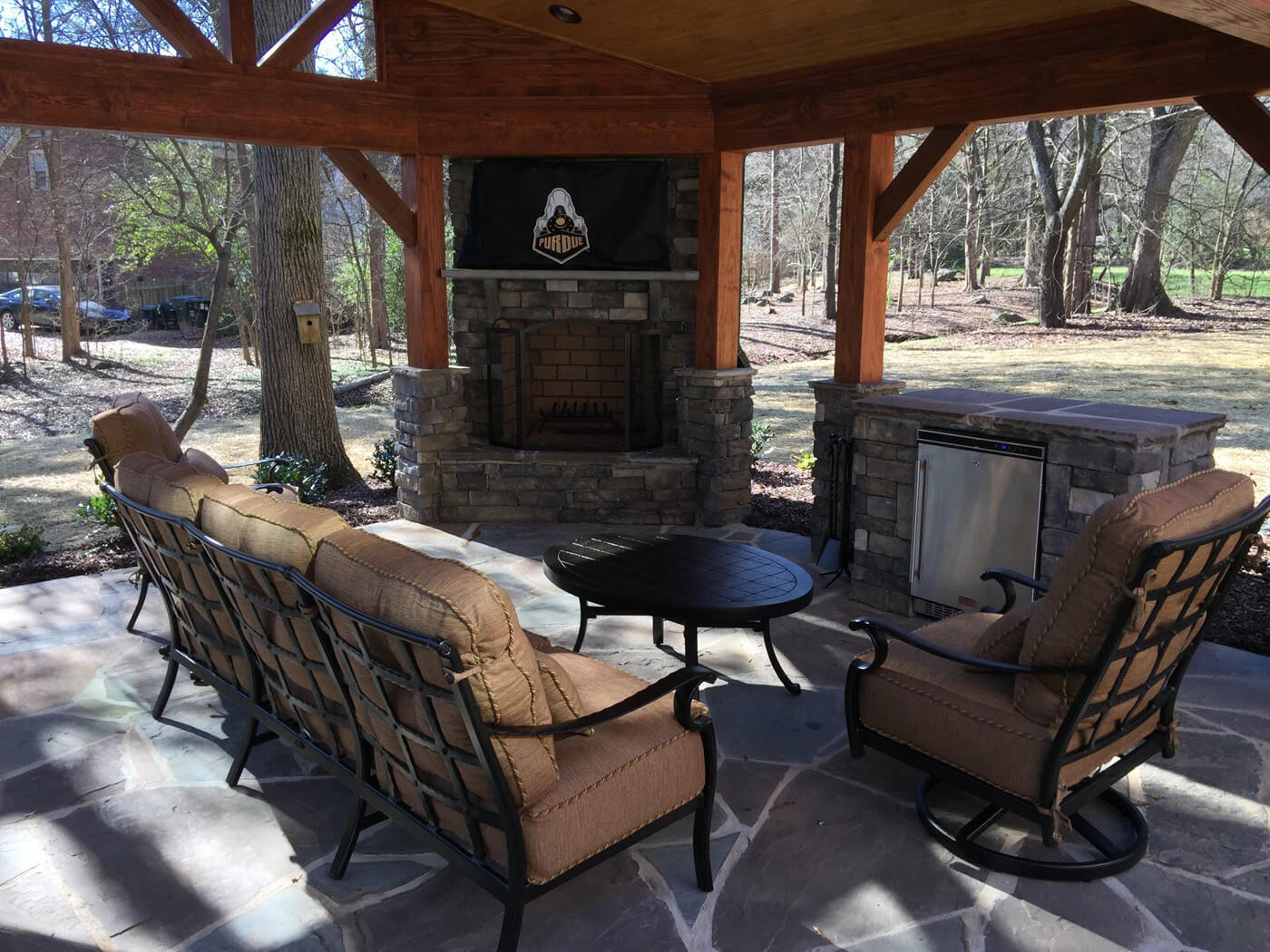 covered porch with built in fireplace and barbecue