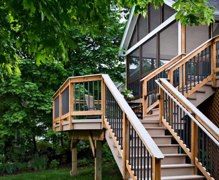 Elevated screened in porch with stairs leading down to ground level