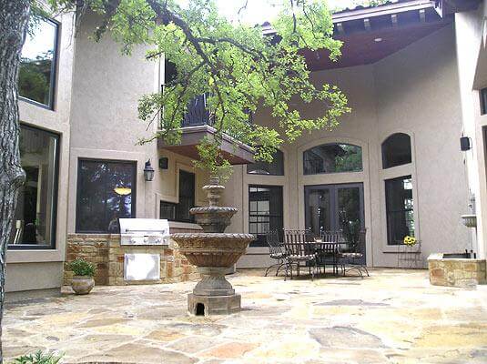 patio with fountain and outdoor kitchen