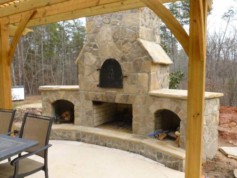 outdoor stone fireplace with built in storage