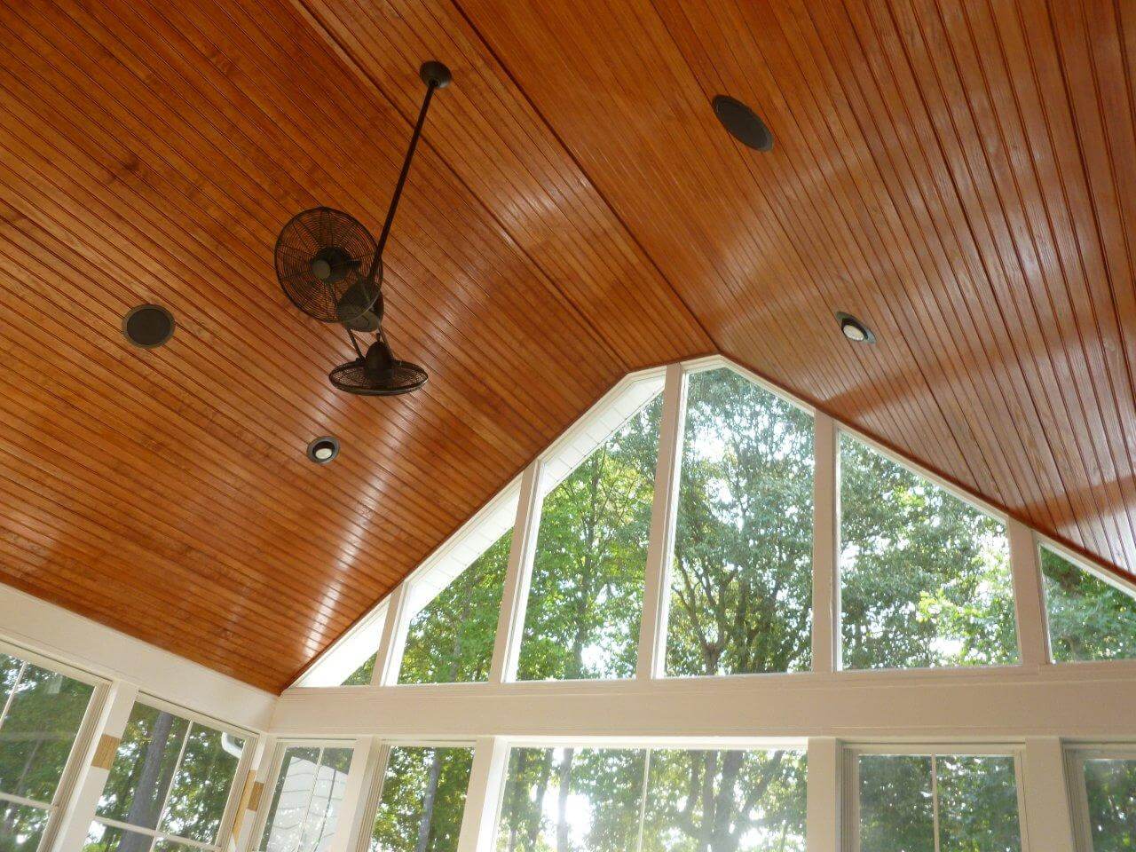 vaulted ceiling on a porch with a ceiling fan