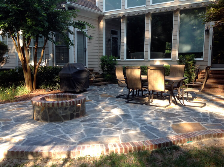 Myers Park fire pit on a patio with outdoor furniture and barbecue