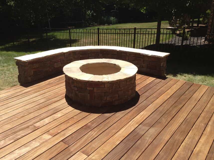 outdoor firepit and seating wall built on a deck