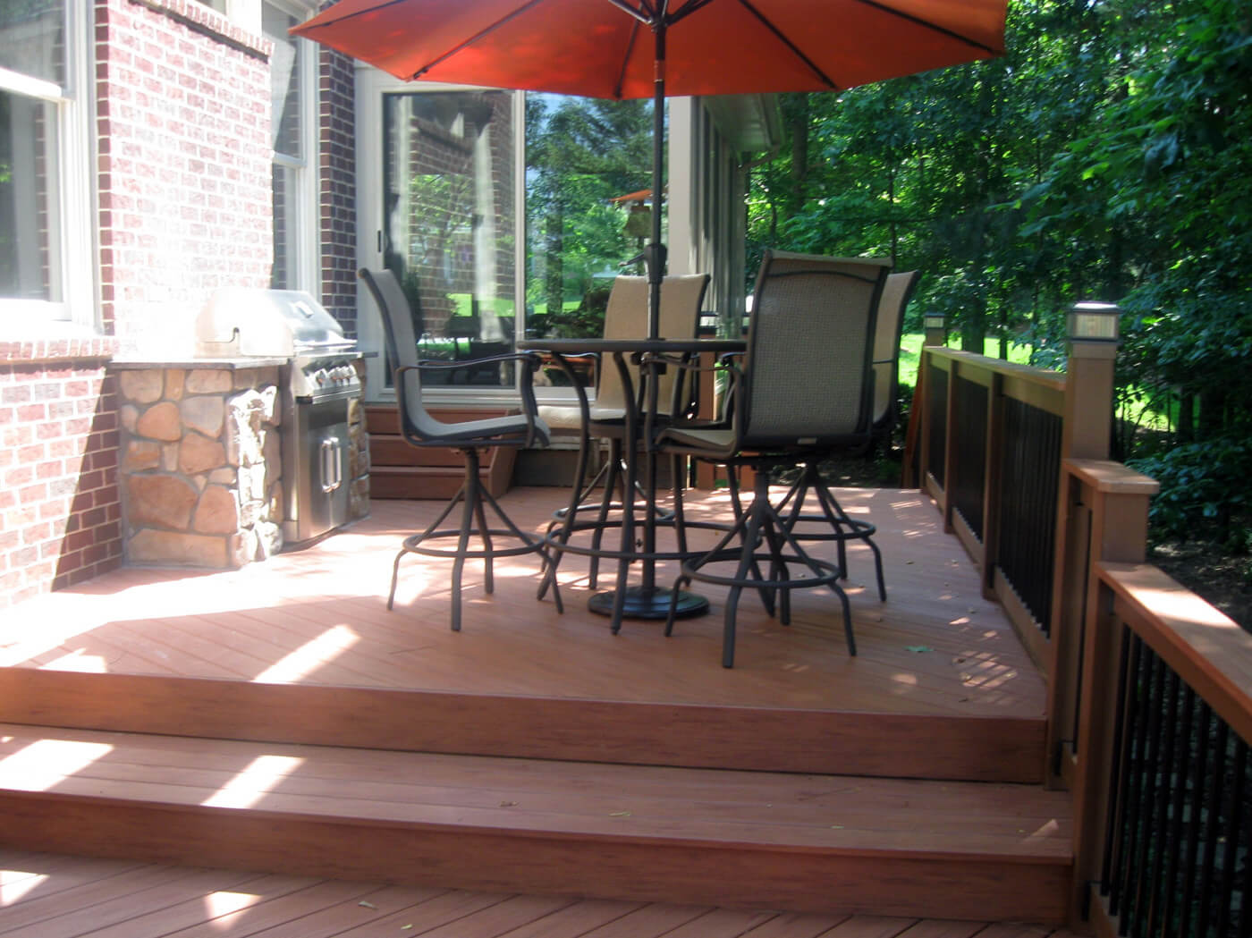 deck with built in barbecue and patio furniture