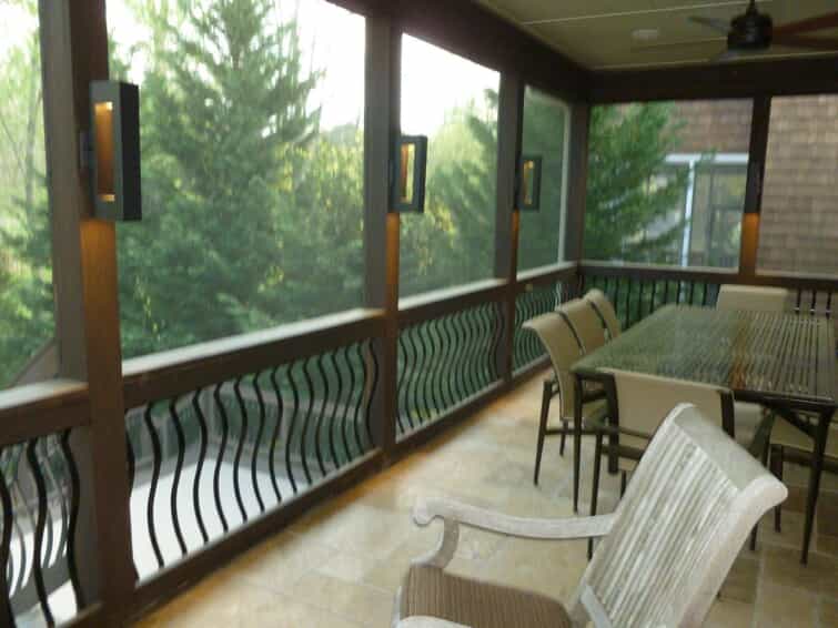 screened-in porch with tiled floor and railing