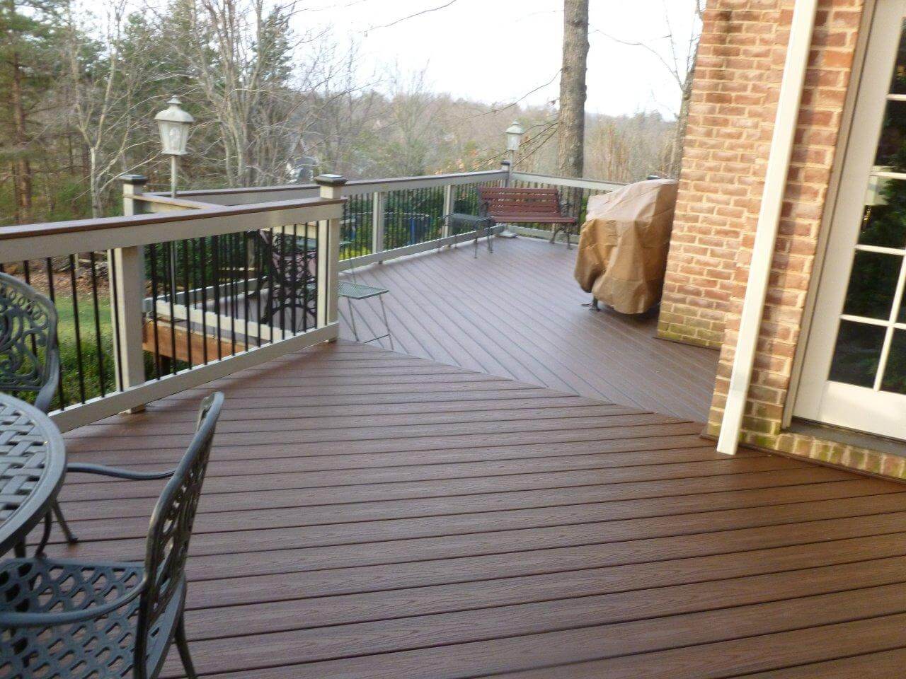 Custom backyard wood deck with railing
