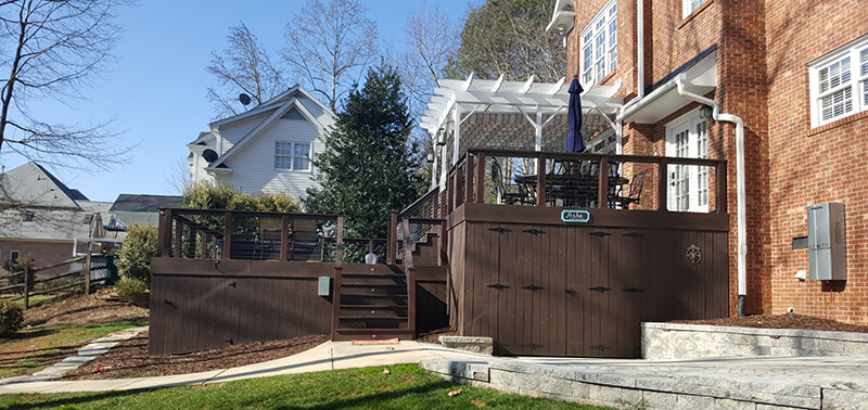 Custom deck and patio with railing and pergola