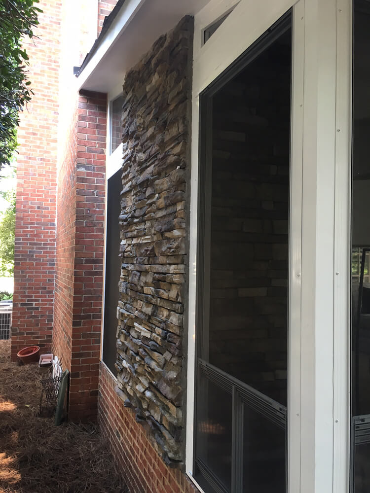 Custom porch with stone facade on outdoor fireplace