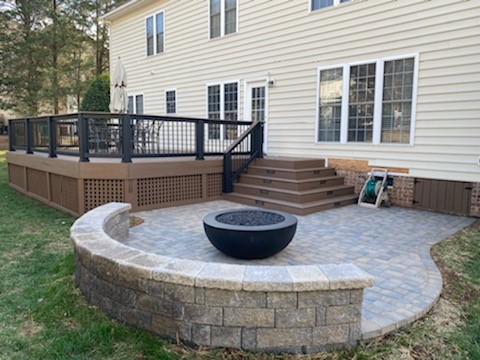 hardscape with outdoor firepit and seating bench