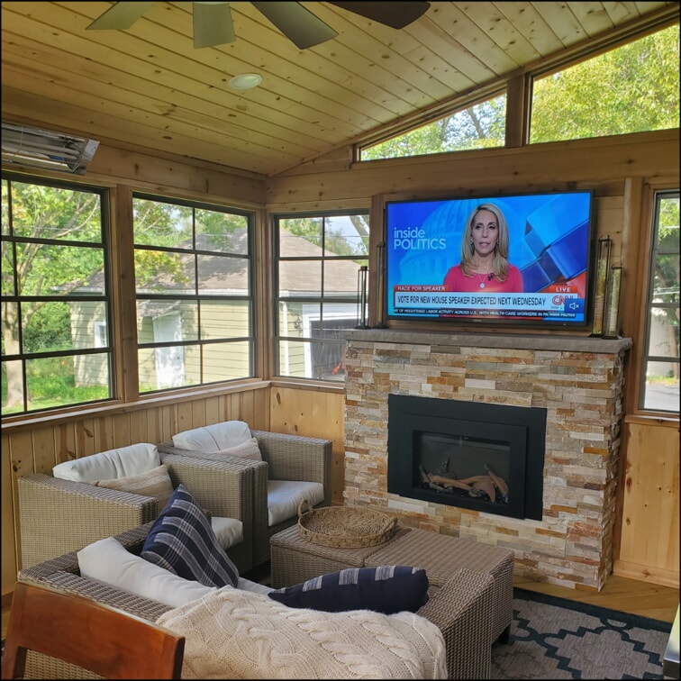 screened in porch with large fireplace 
