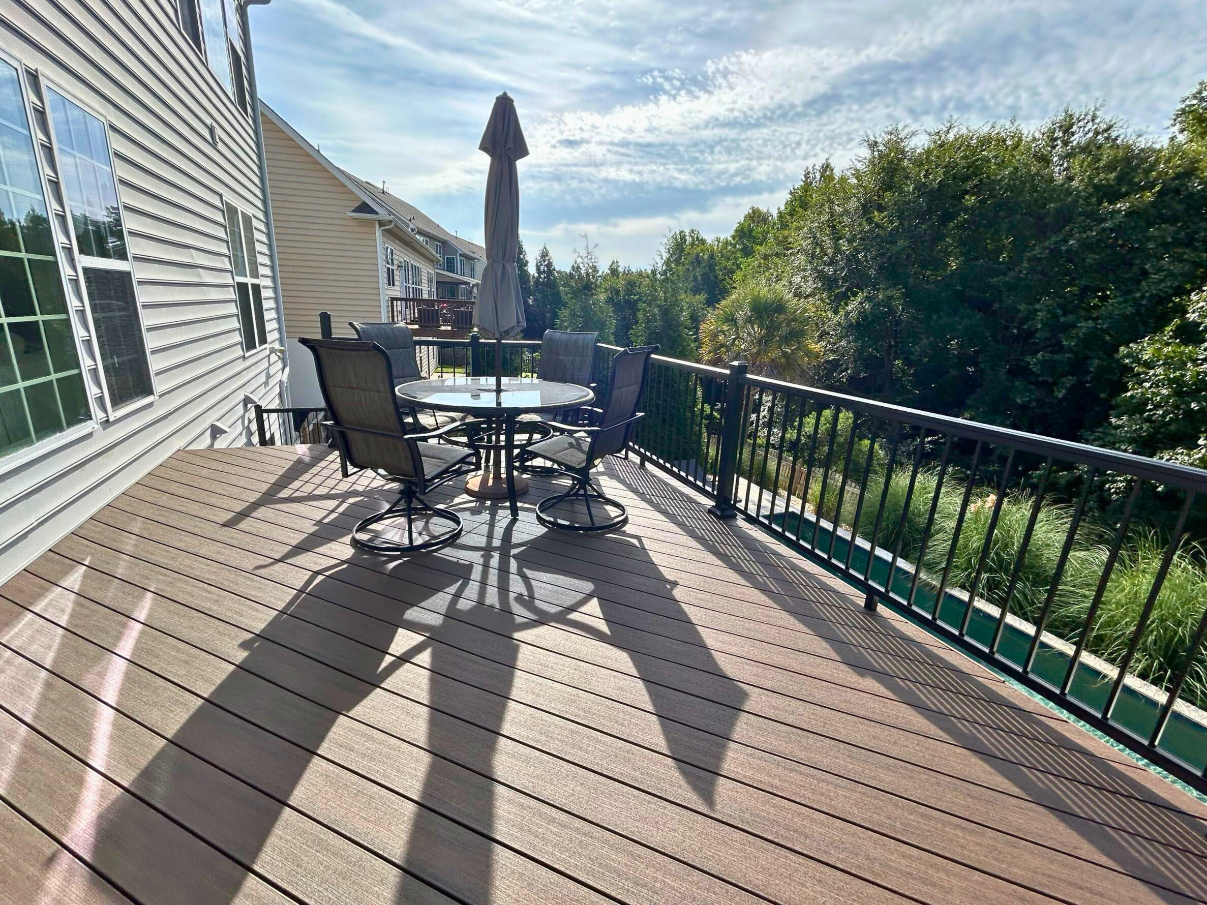 Spacious Indian Land composite deck in Trex Toasted Sand, featuring black railings, perfect for outdoor living and entertaining.