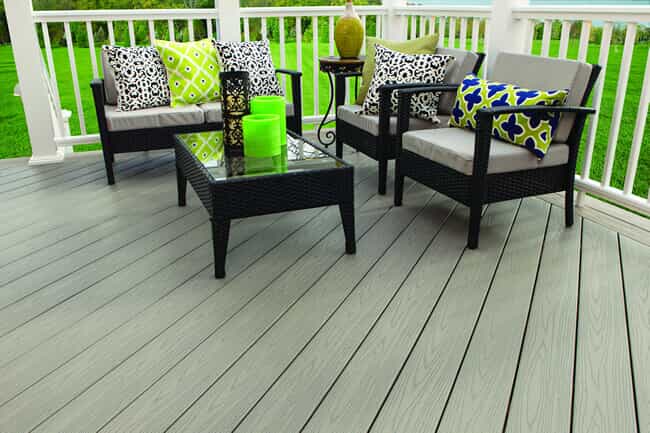 Deck with railing and black and white outdoor furniture