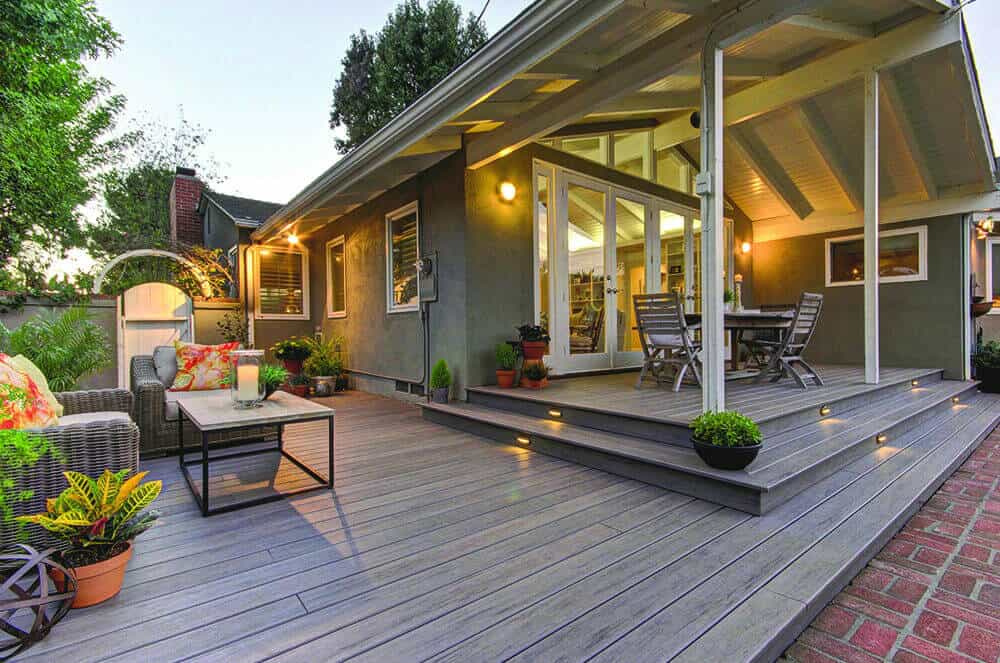 composite deck with lit stairs and outdoor furniture