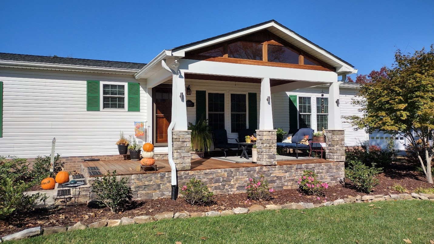 front porch with pumpkins and mums