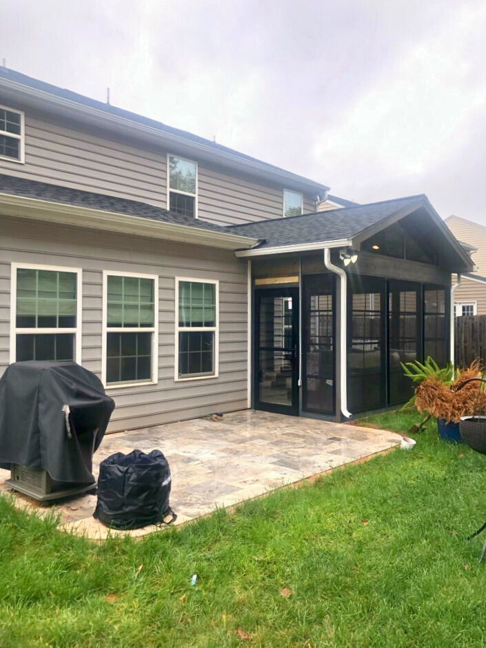 Screened porch connecting to a stone paver patio, expertly built in Fort Mill, SC.