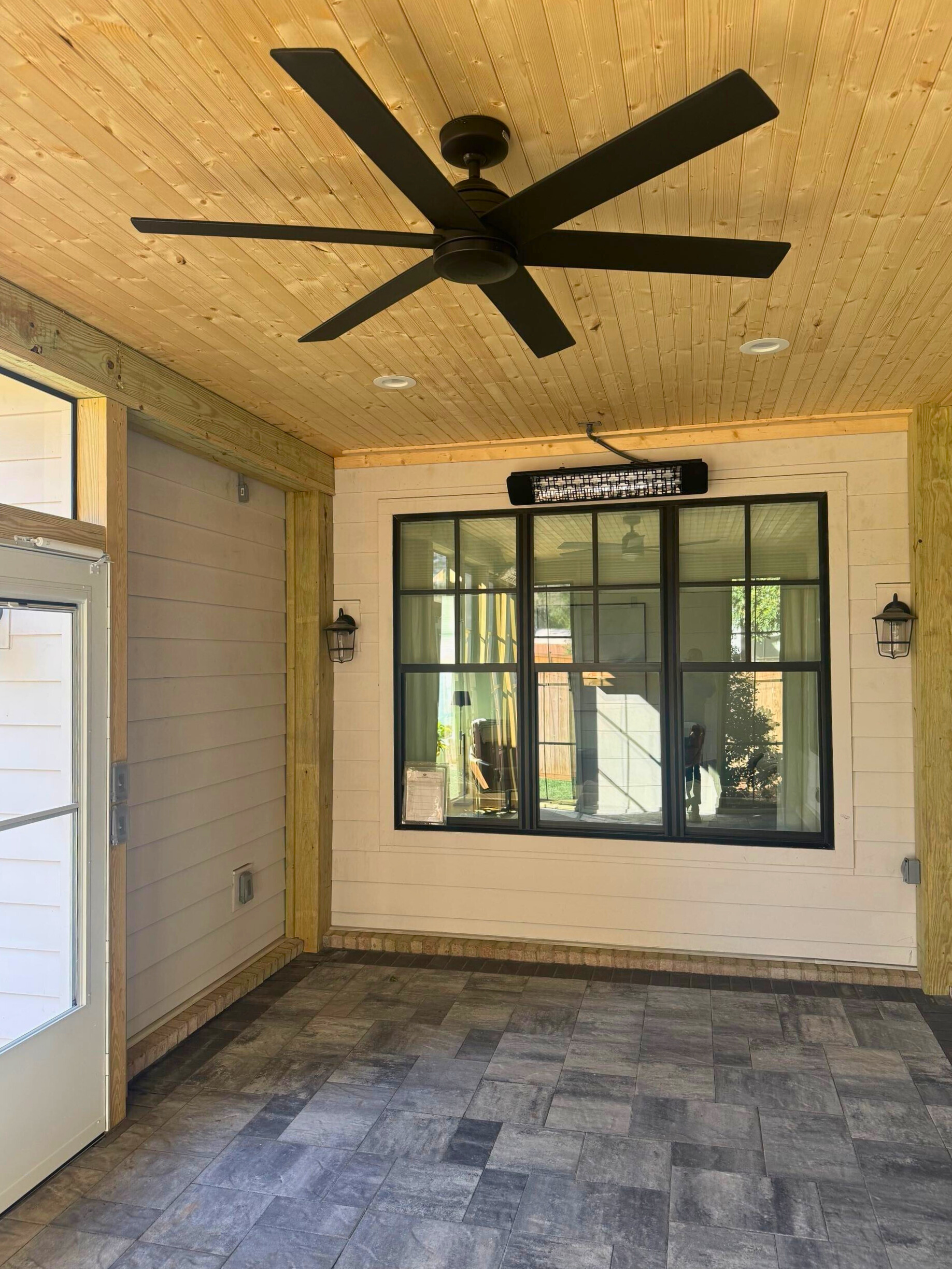 Eze-Breeze three-season porch in Tega Cay with wood ceiling, fan, and large black windows