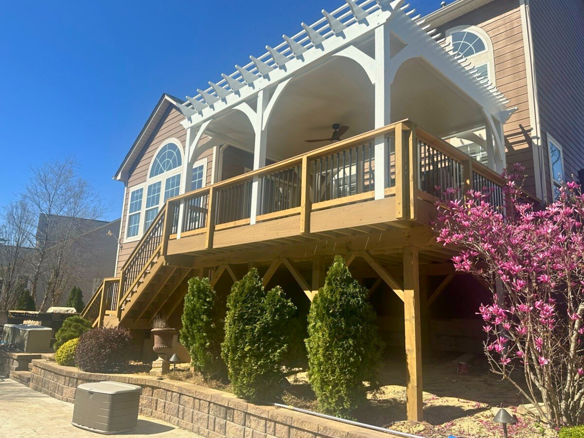 Composite deck with white pergola and arches, extending from a Tega Cay home