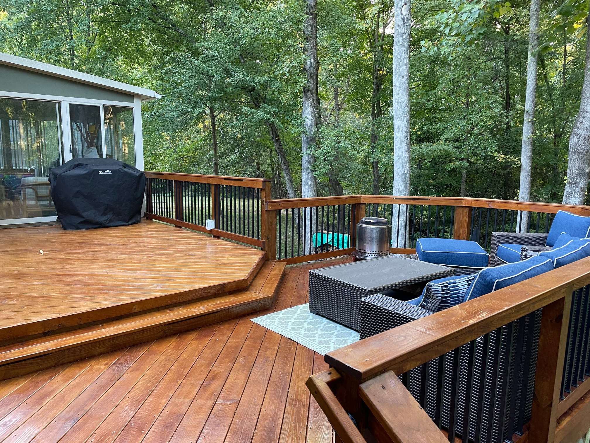 Expansive stained wood deck with multiple levels and outdoor seating area, built by a deck builder near Monroe NC.