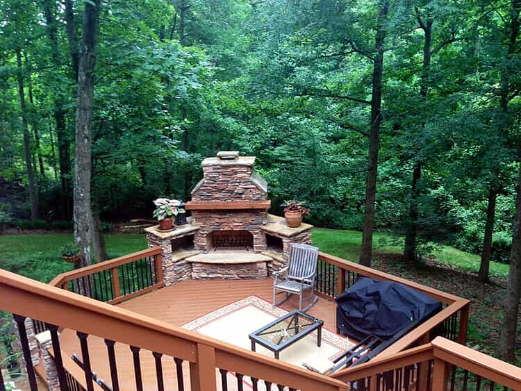 deck with built in fireplace and outdoor furniture