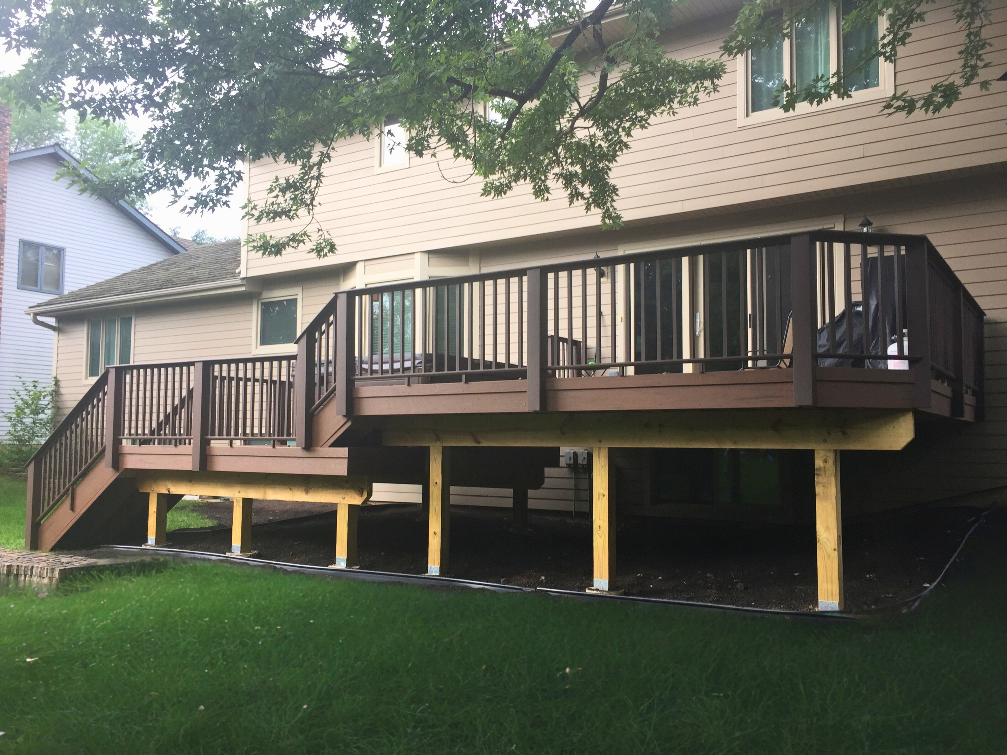 Dark brown composite deck with matching railings, built by a professional deck builder in Libertyville IL.