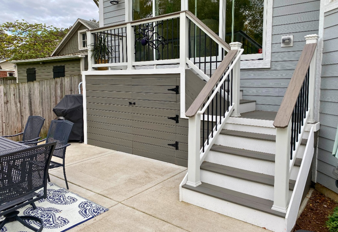 This beautiful multi-level composite deck features a stylish railing design and integrated storage with a hidden trap door, offering both aesthetics and functionality to a Wheaton home.