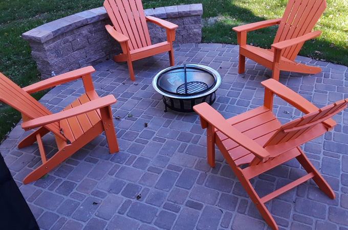 Gather around this cozy fire pit on a custom paver patio, complete with comfortable Adirondack chairs, a perfect addition for evening enjoyment at your Wheaton home.