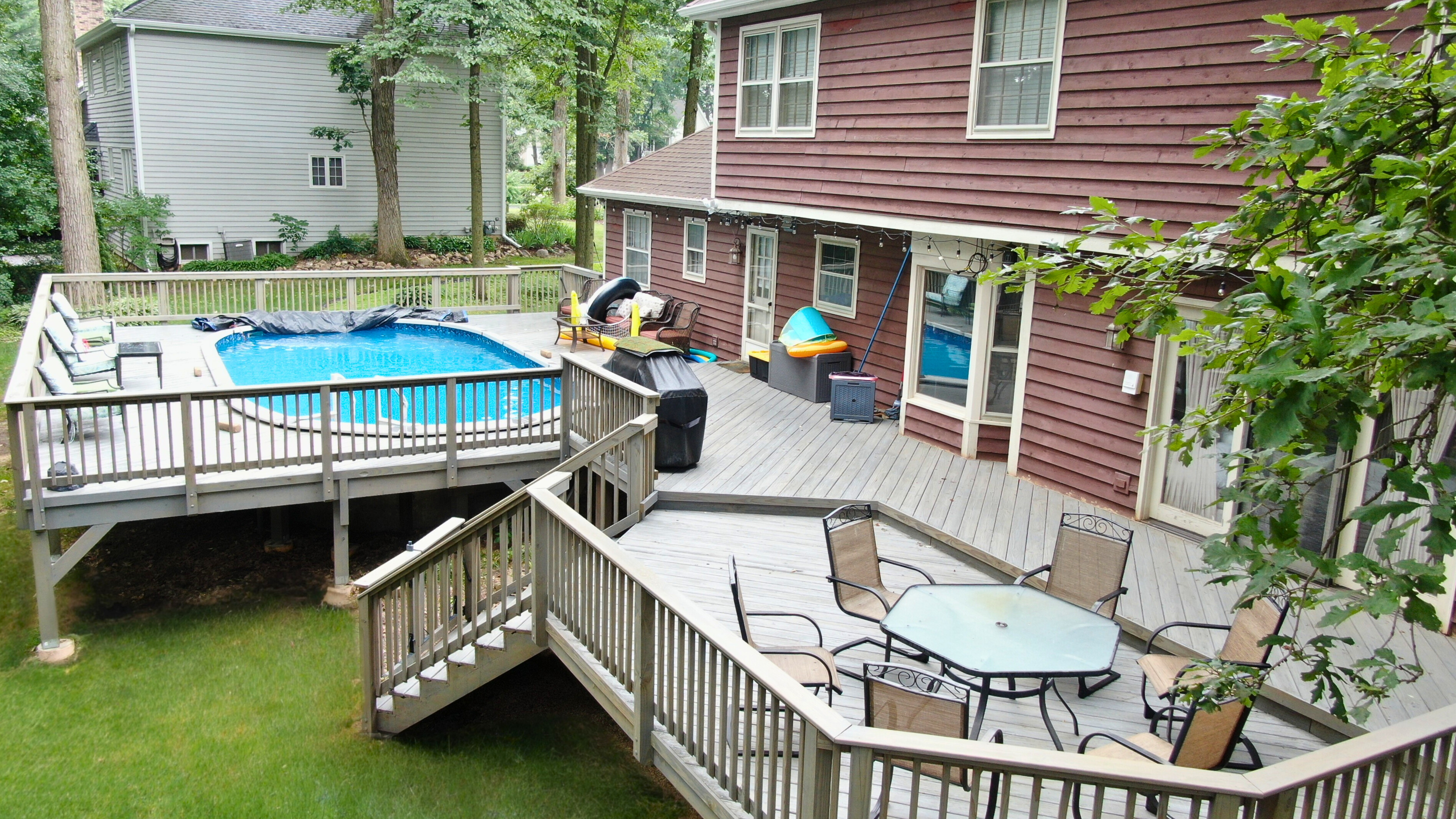 A grand multi-level deck in Bartlett designed for extensive outdoor enjoyment, complete with a pool and multiple seating areas.