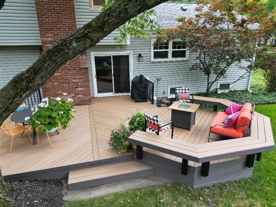 deck with patio furniture, bonfire, and plants