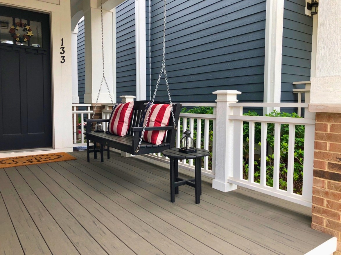 Composite porch deck with a swing and white railings on a home in Libertyville IL