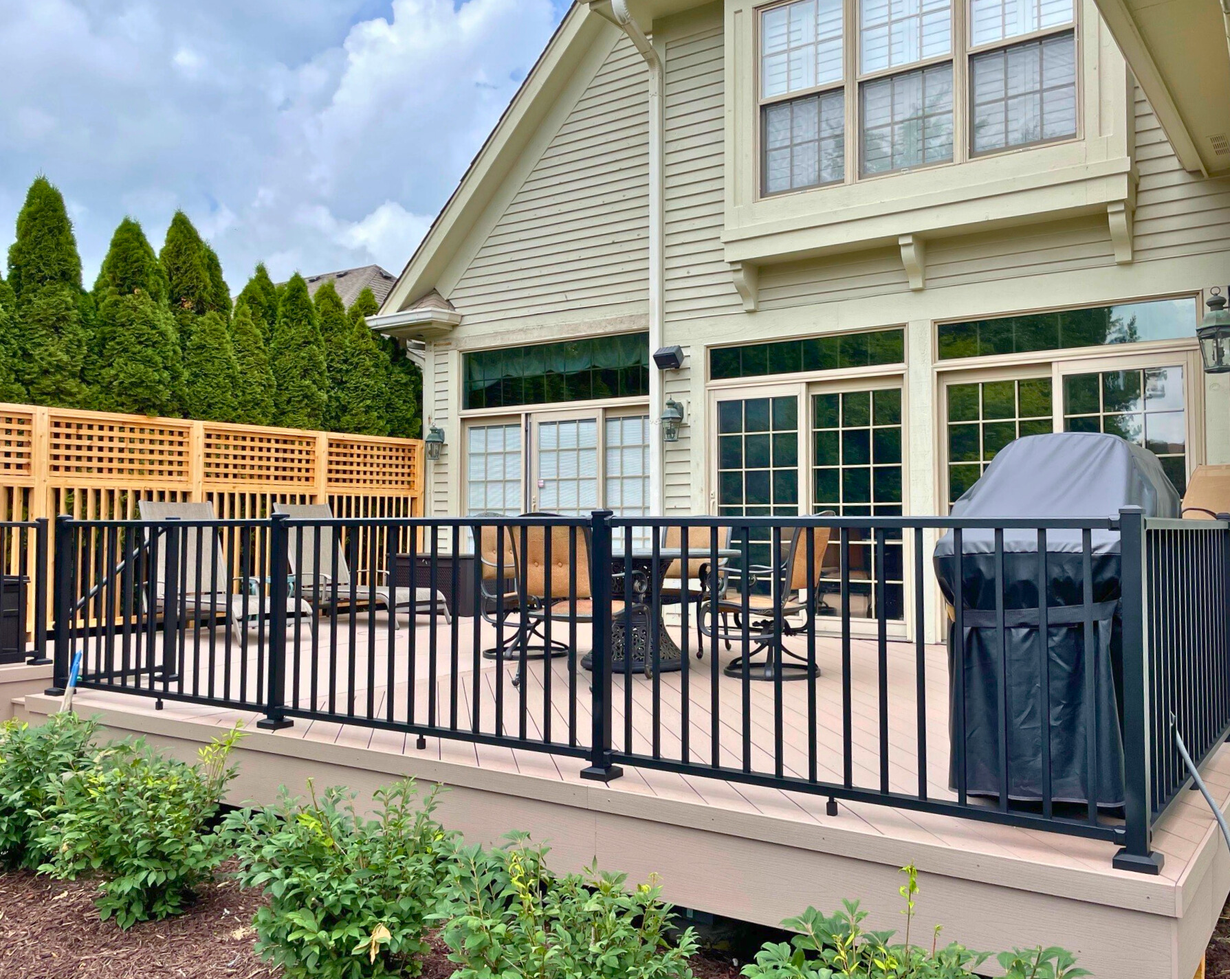 Custom composite deck with black metal railing and grill, Barrington, IL.