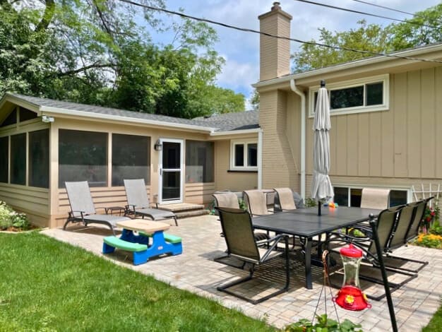 Custom screened porch and paver patio with outdoor dining area in Highland Park, IL