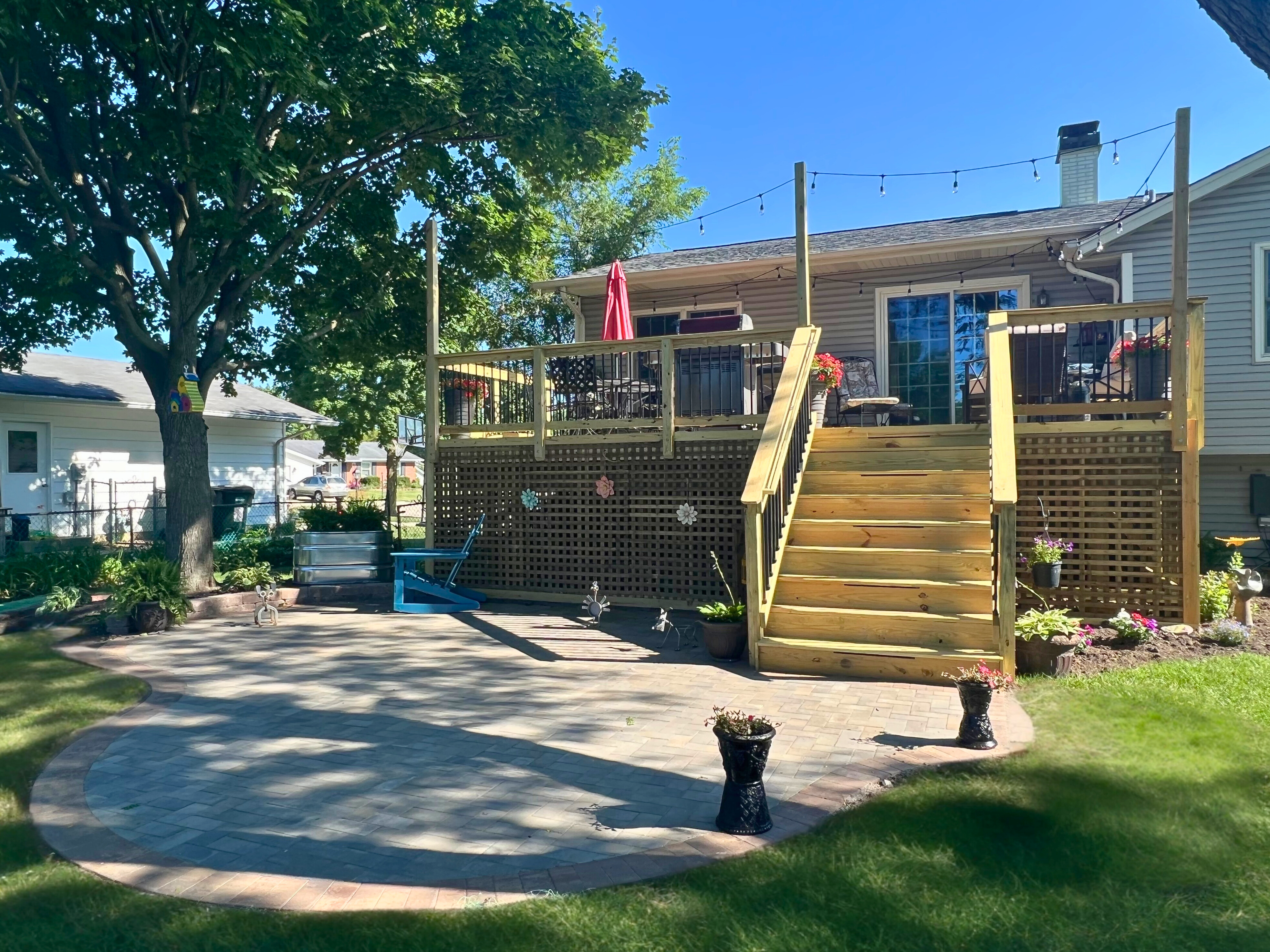 Spacious, custom-designed paver patio with seating area behind a house in Hoffman Estates.