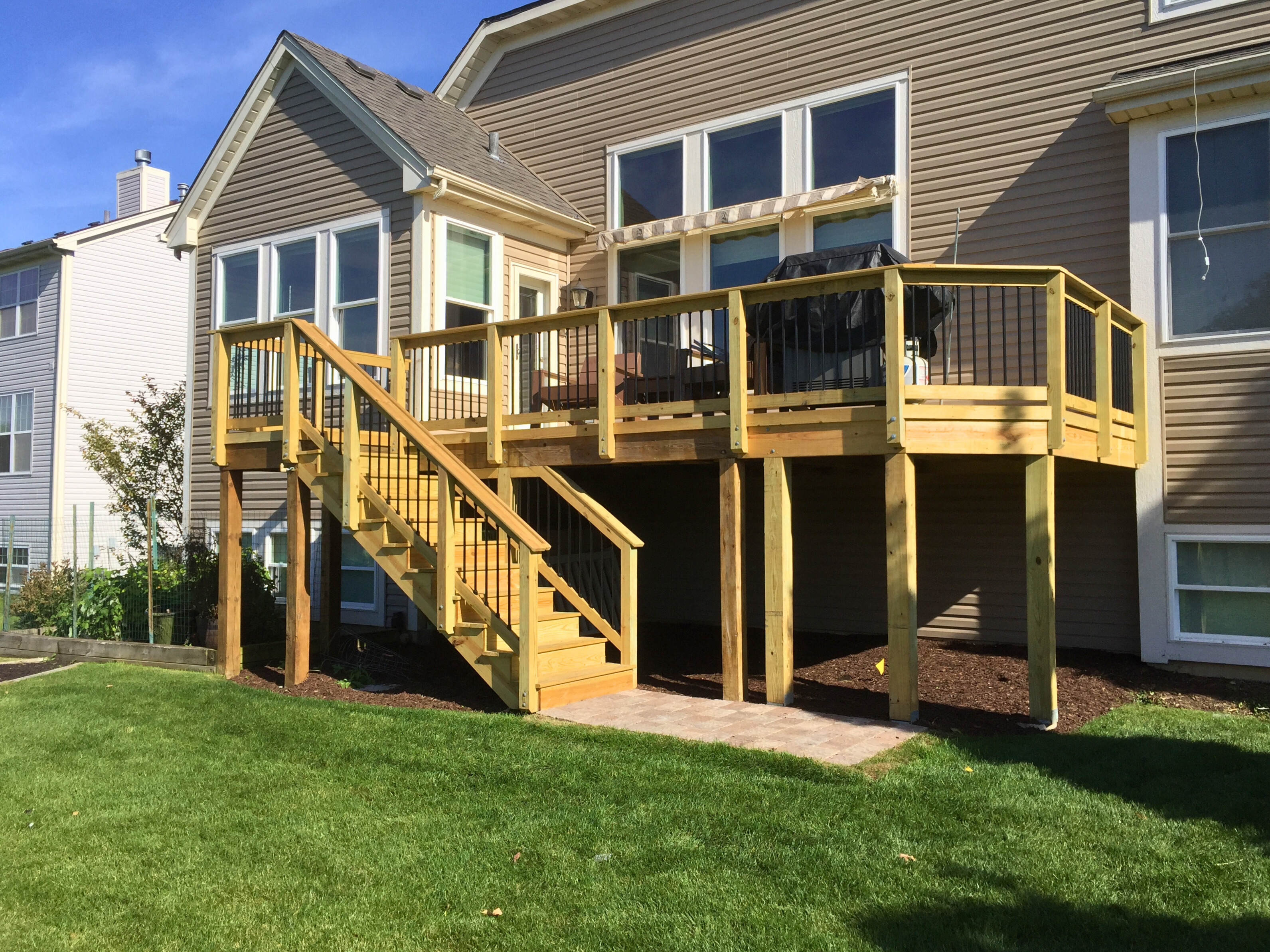 Beautiful TimberTech composite deck with white railing and dark balusters, with vertical skirting in Hoffman Estates.