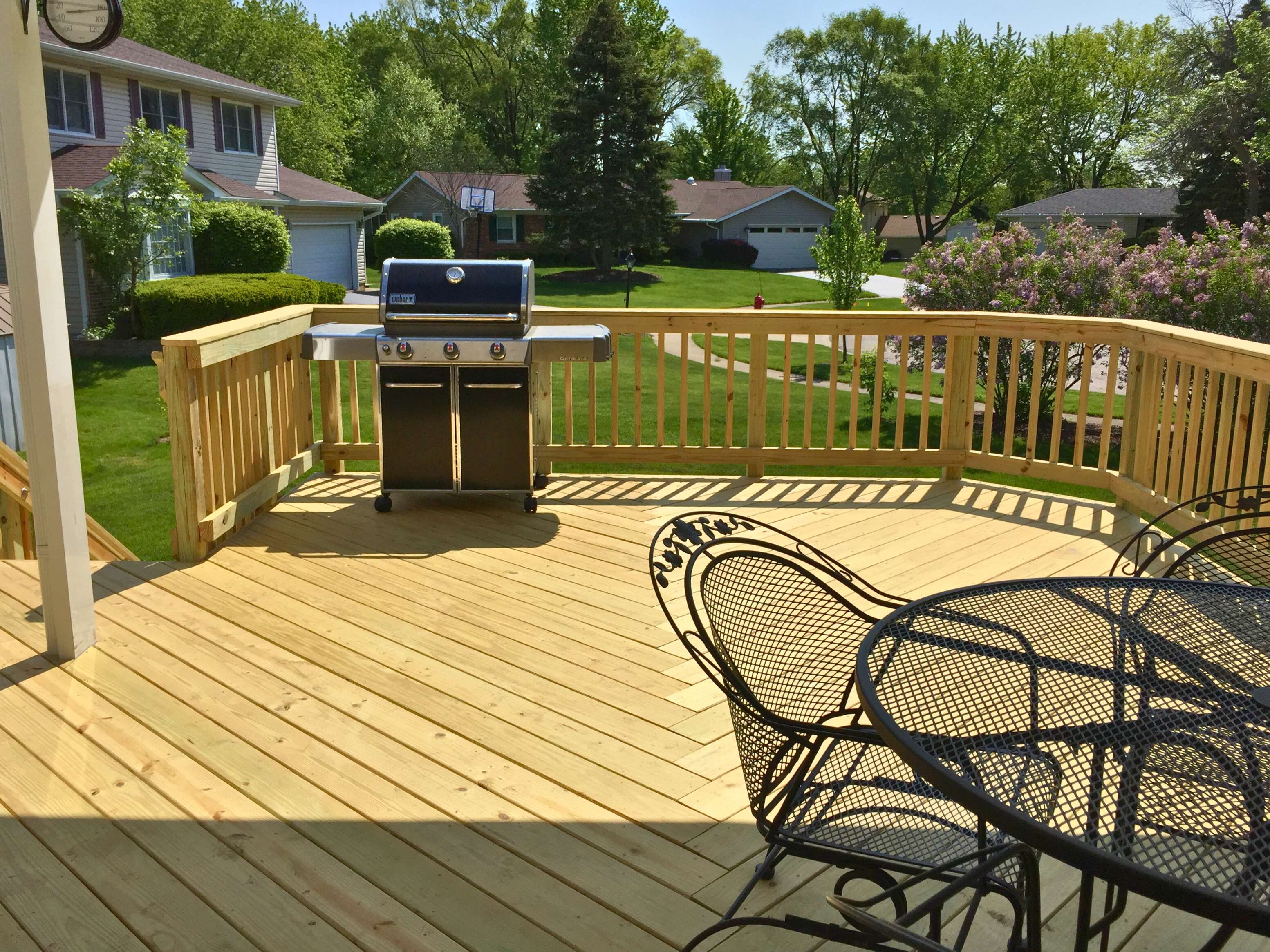 Large composite deck with white railing and dark accents designed and built in Hoffman Estates, IL.