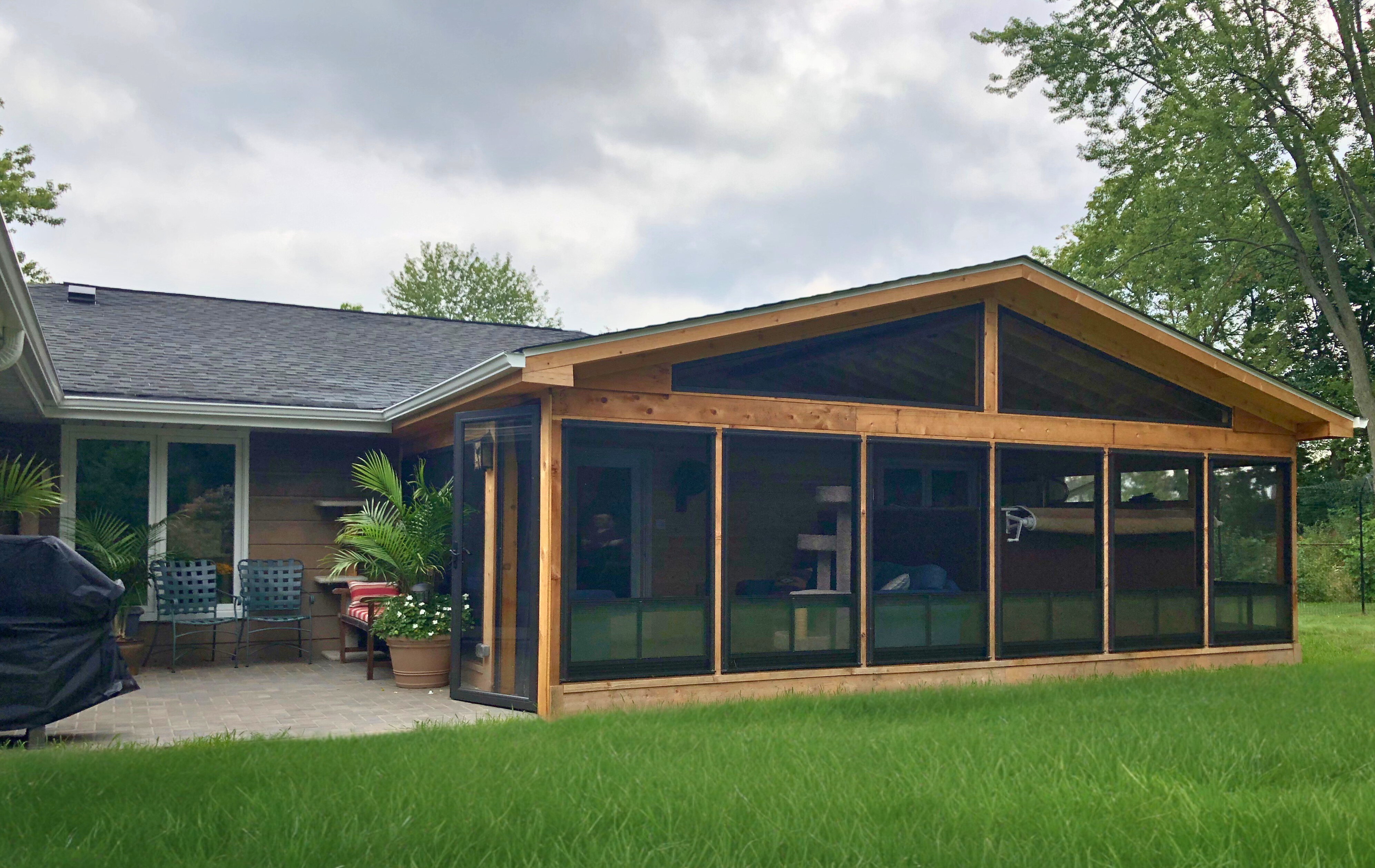 Expansive, multi-level composite deck with white railings and dark accents, overlooking a green backyard in Hoffman Estates.