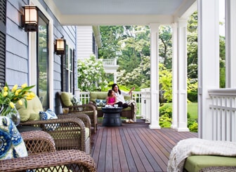 front porch with mother and daughter sitting on bench 