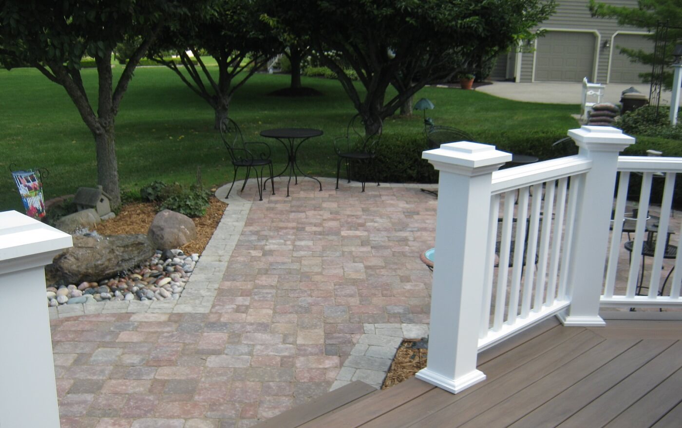 Deck and patio with white railing and patio furniture