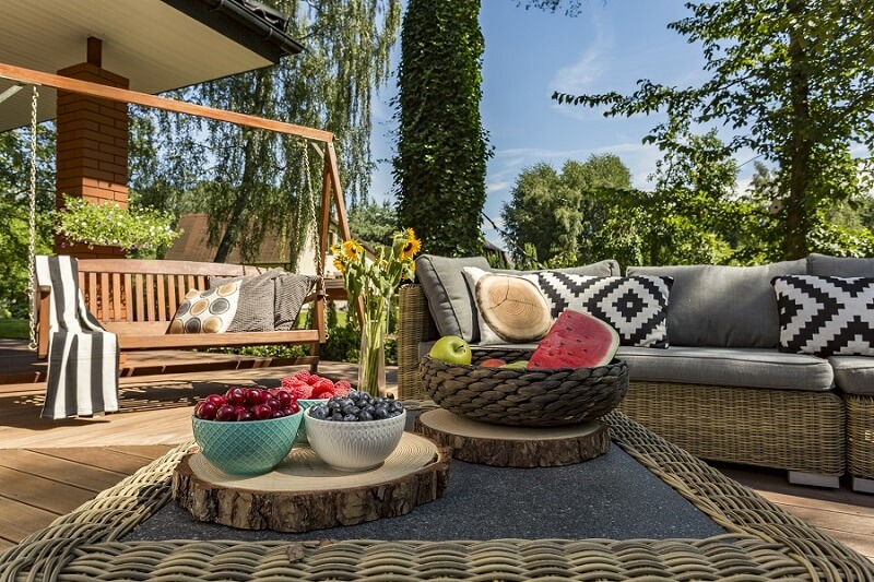 wood deck with couch and fruits