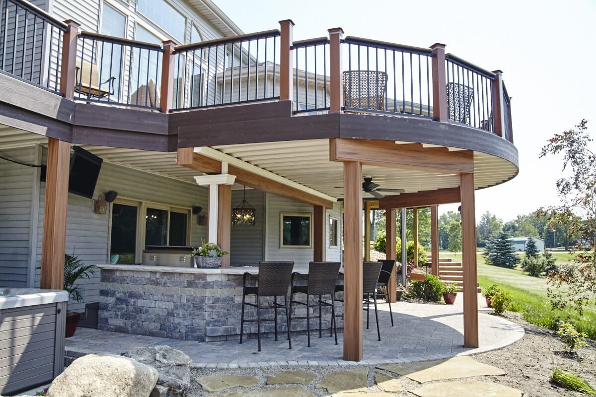 Under deck patio with outdoor kitchen and bar counter