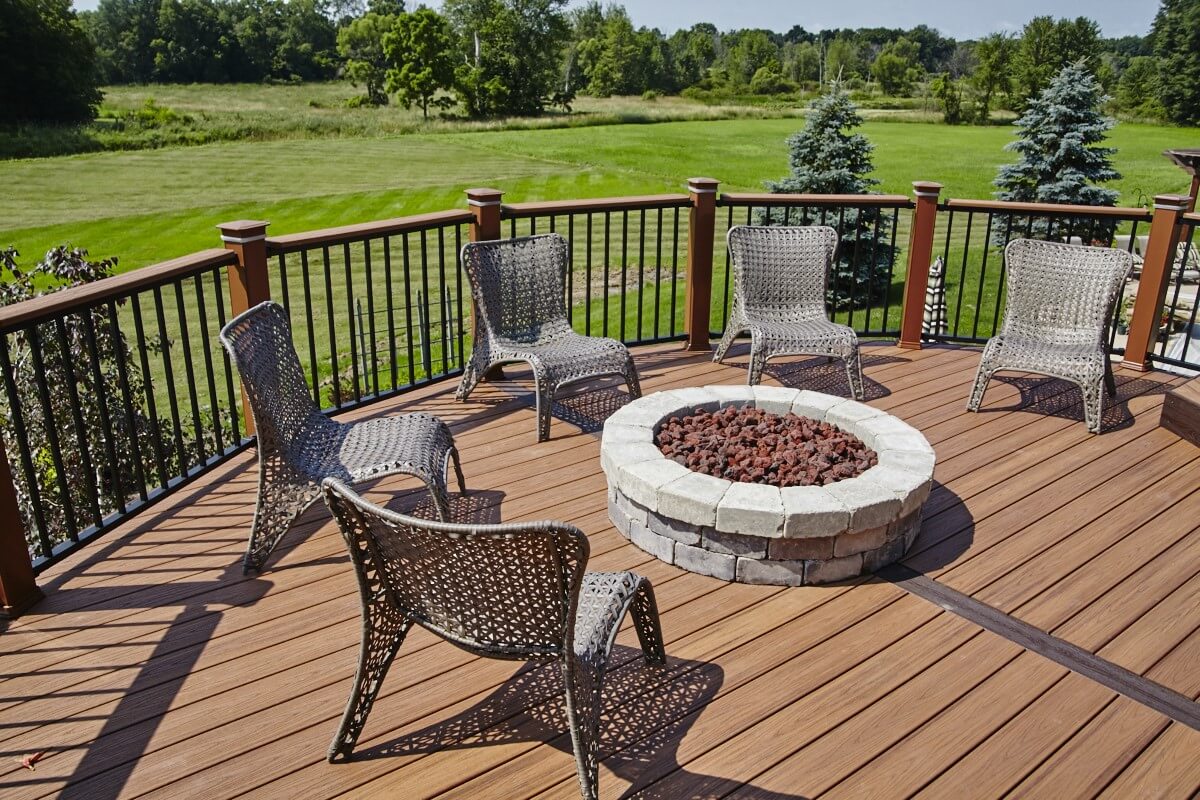 Custom backyard deck with stone fire pit